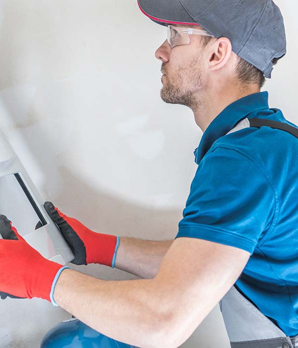 House Heating Unit Repair by Professional Technician. Closeup Photo. Home Equipment Issues.