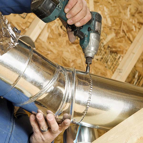 Worker Installing an Attic Vent Duct
