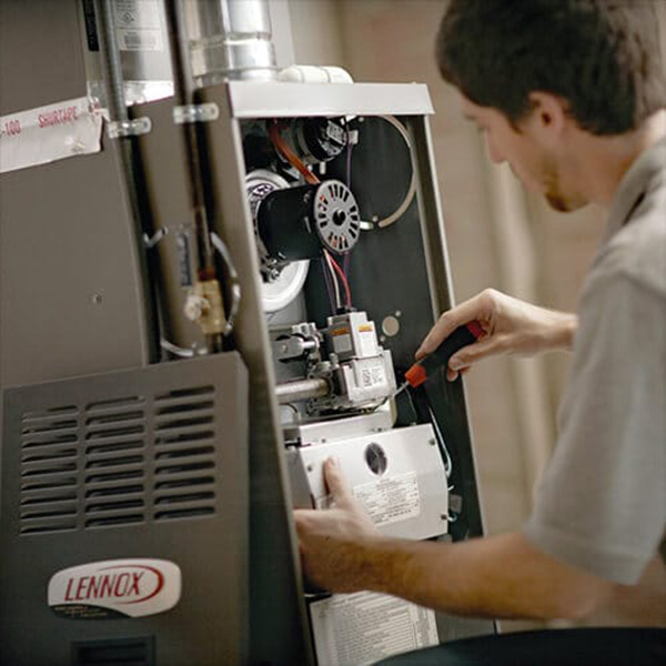 a man repairing furnace panel