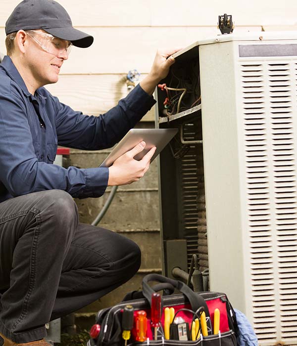Technician Repairing Air Conditioner Outside in Hunterdon County, NJ